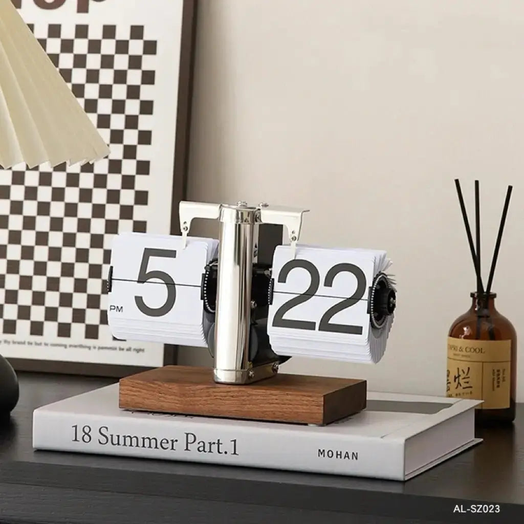 Retro flip desk clock with light face and wooden base, chrome center column