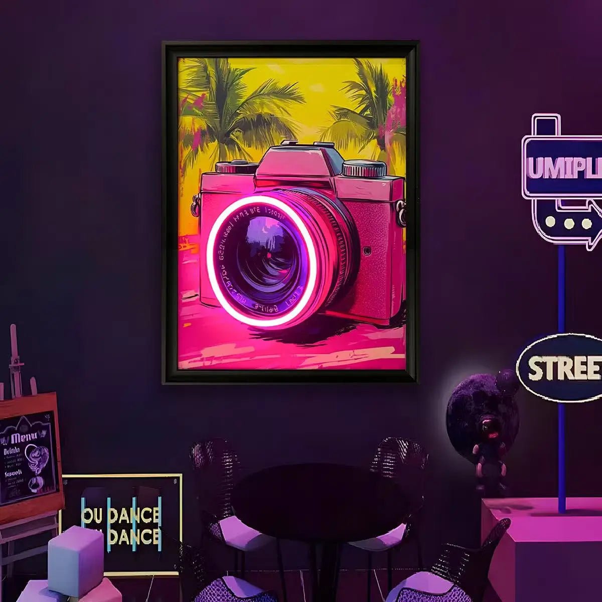Framed LED wall art with pink camera graphic, magenta neon lens glow