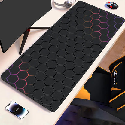Hex-pattern technical drawing desk pad with pink outline accents on dark surface