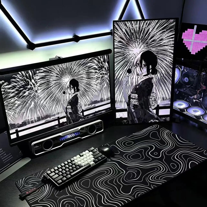Black desk mat with white topographic contour line pattern and stitched edges