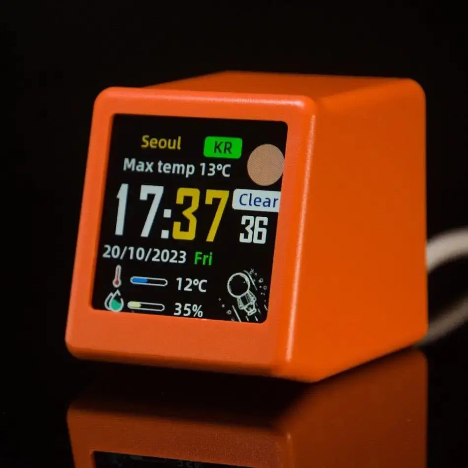 Mini smart weather station in orange with close-up digital display showing outdoor conditions