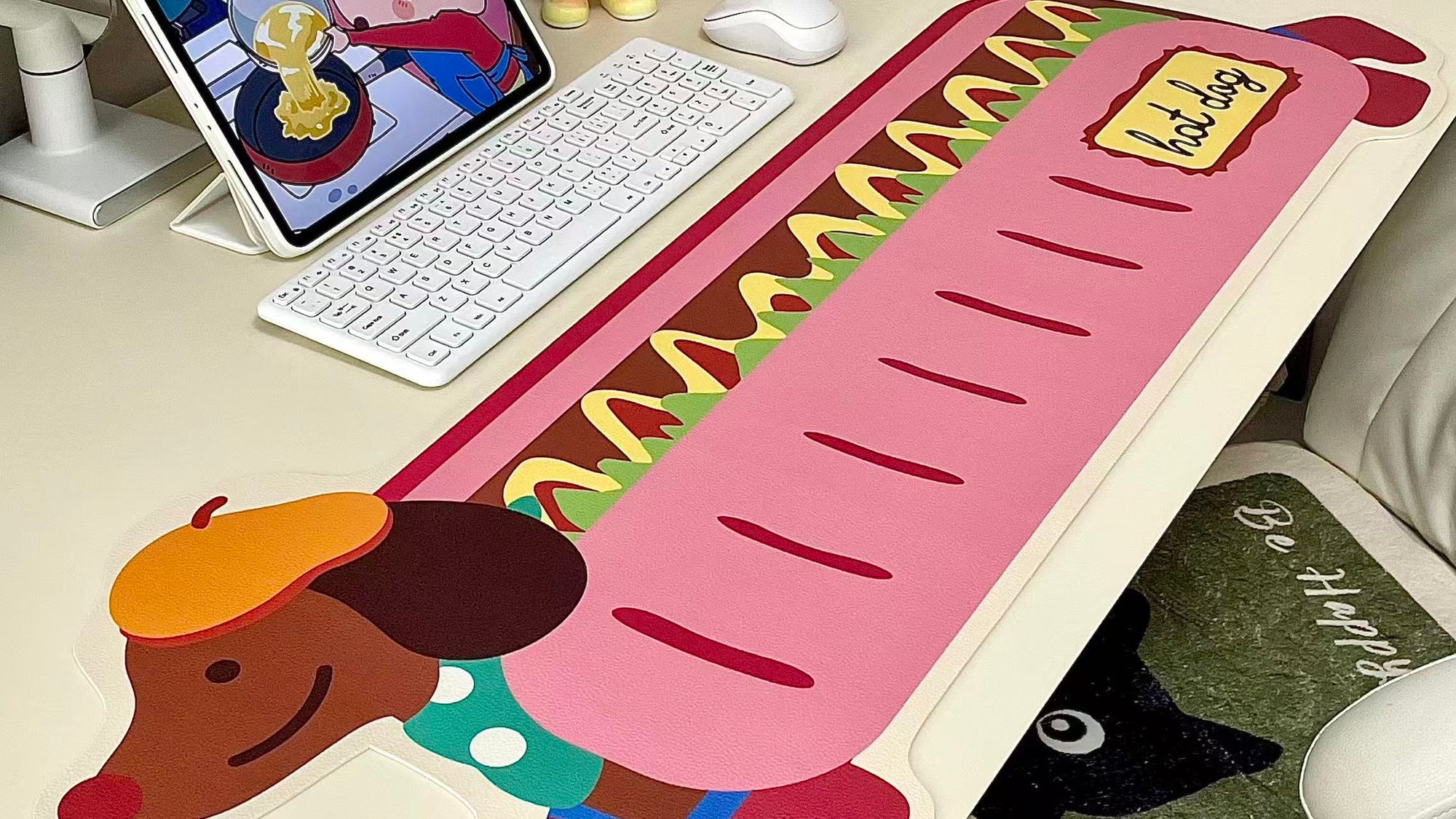 Custom desk mat with pink cartoon food and animal characters along a long banner