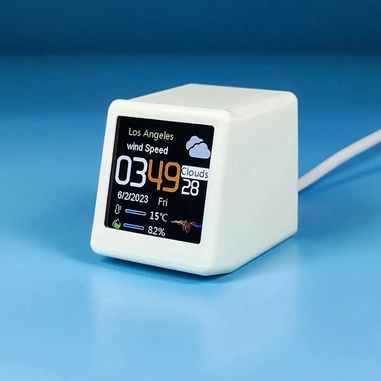 White mini smart weather station with digital screen showing time, date, wind speed