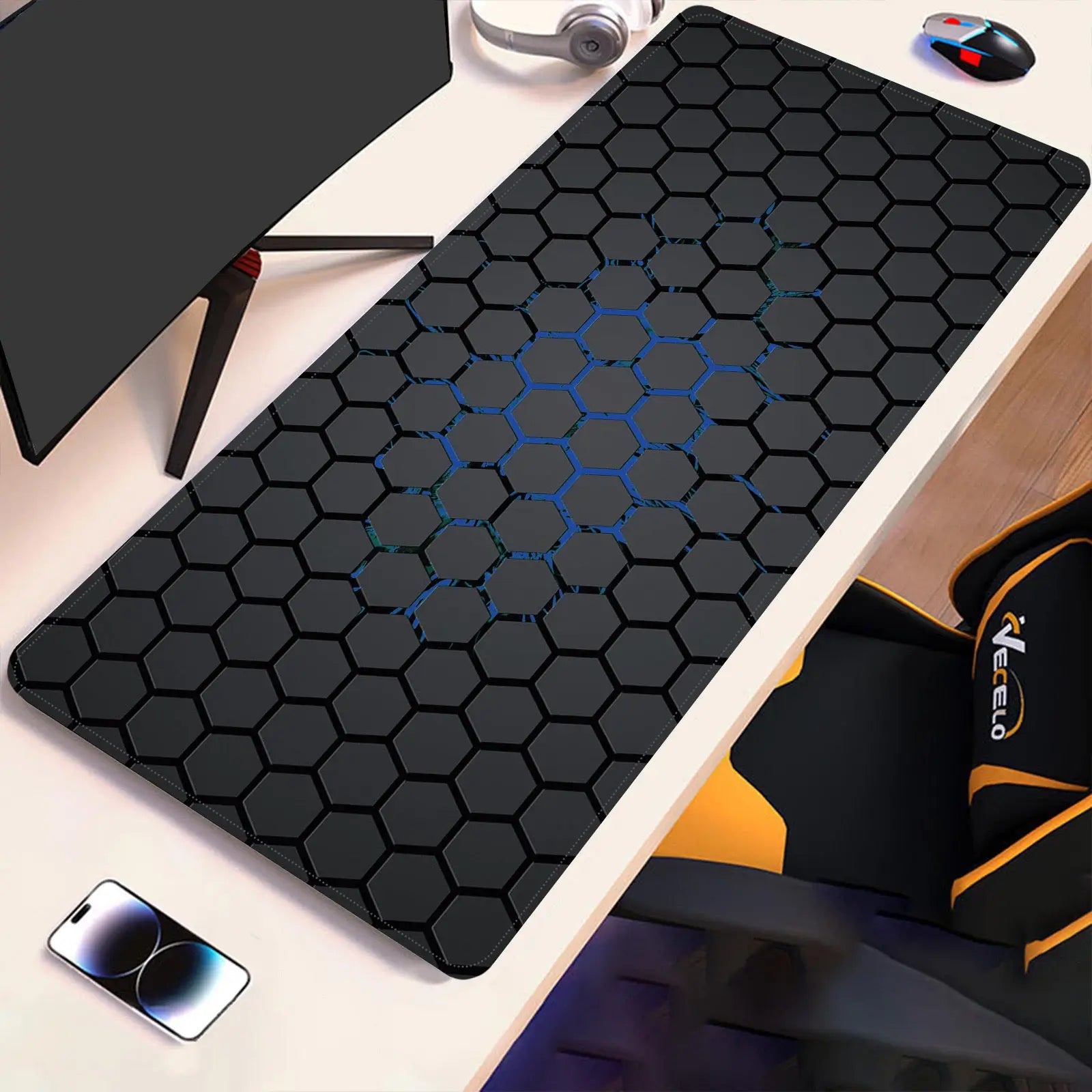 Hex-pattern technical drawing desk pad with blue accents on dark surface