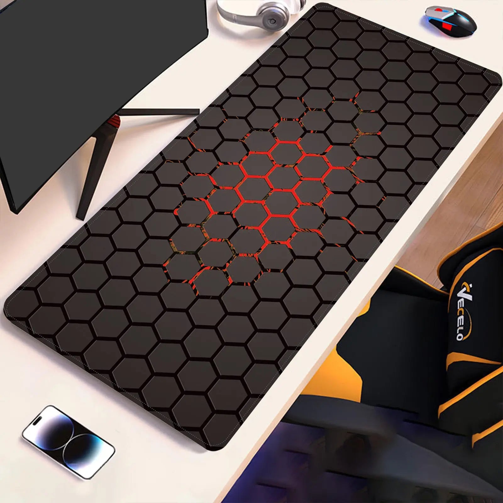 Hex-pattern technical drawing desk pad with red accents on dark surface