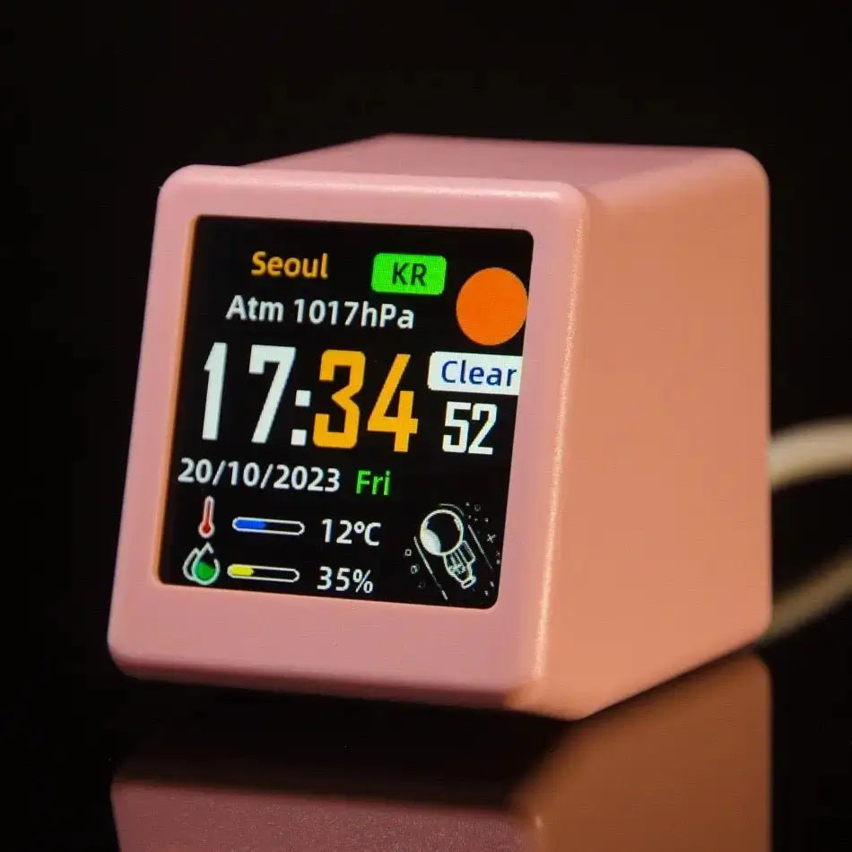 Mini smart weather station in pink with close-up digital display showing outdoor conditions