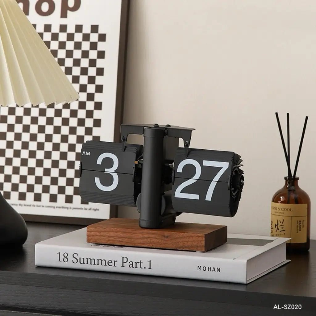 Retro flip clock with dark flip pages, numbers 3 and 27, wooden base and stand