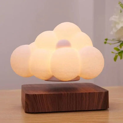 Floating cloud LED lamp with warm glow on dark wood base