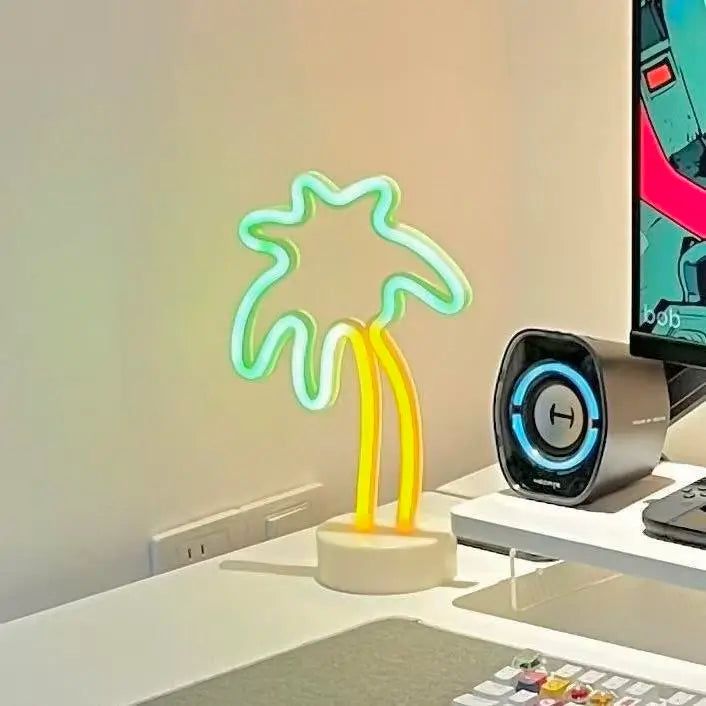 Green monstera neon sign with yellow stem on white base, desk decor glow
