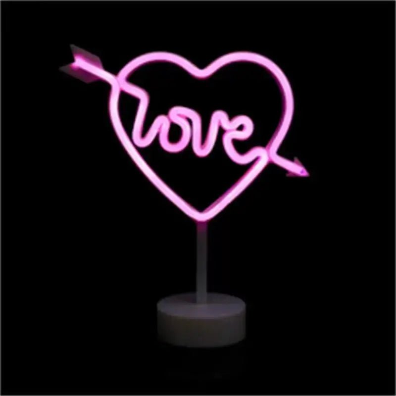Pink heart neon sign with LOVE lettering and arrow accents
