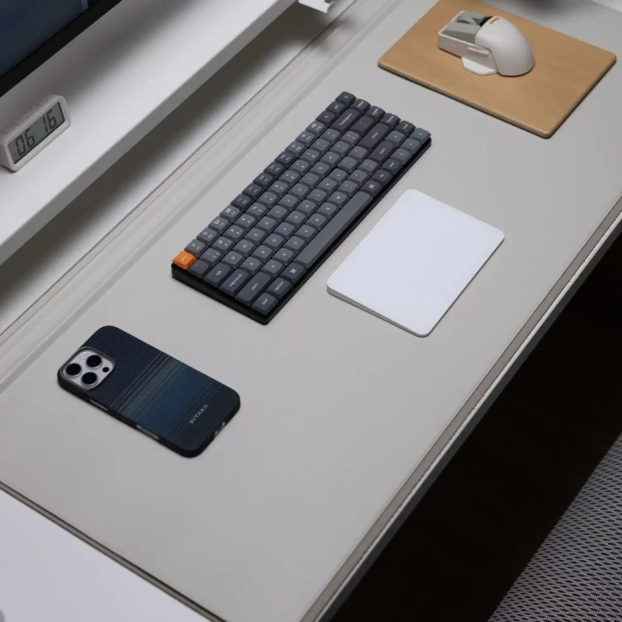 Large waterproof desk mat on desk with smooth light-gray surface and dark edge trim