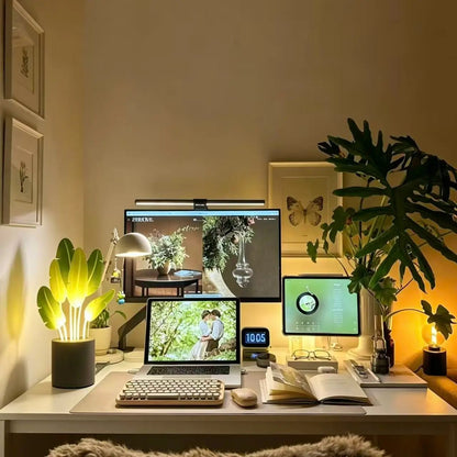 LED snake plant desk light glowing green on dark cement base