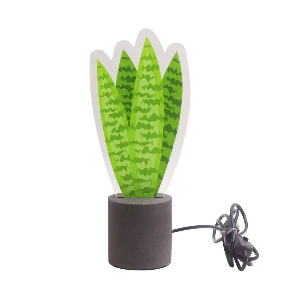 LED snake plant desk light with green leaves, dark base, and connected USB cable