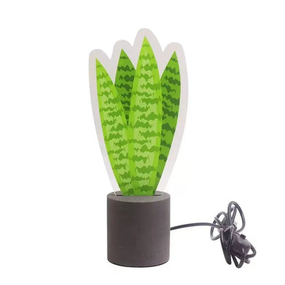 LED snake plant desk light with green leaves, dark base, and connected USB cable