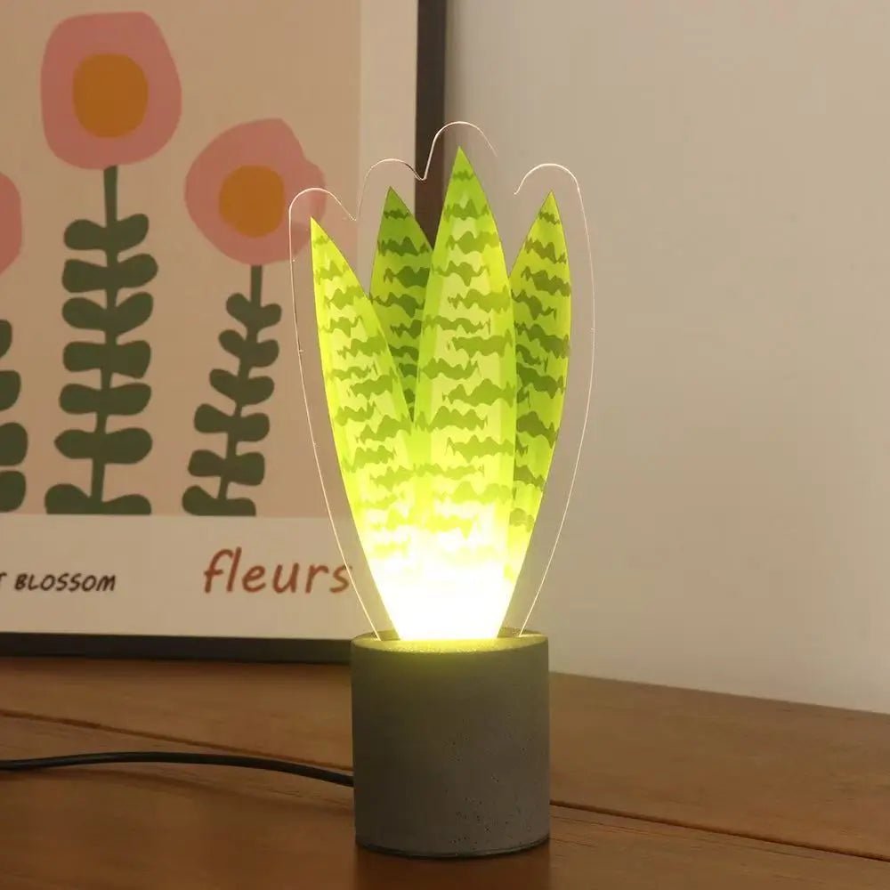 Glowing cactus LED night light in dark base with yellow-green acrylic leaves