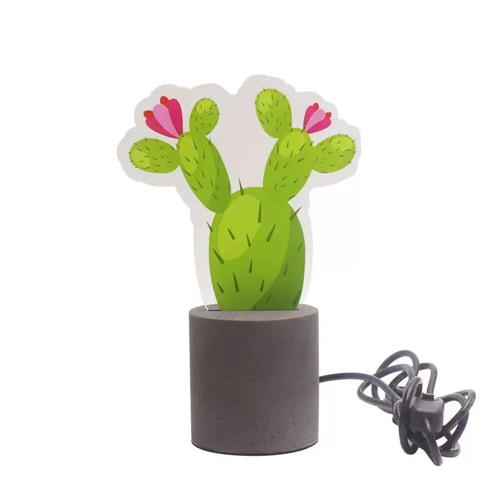 Cactus LED night light with green body, pink blossoms, and dark cement base