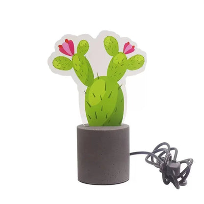 Cactus LED night light with green body, pink blossoms, and dark cement base