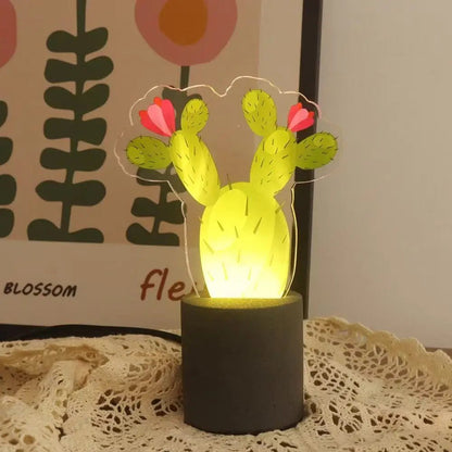 Glowing cactus LED night light with bright yellow light, dark cement base, pink flowers