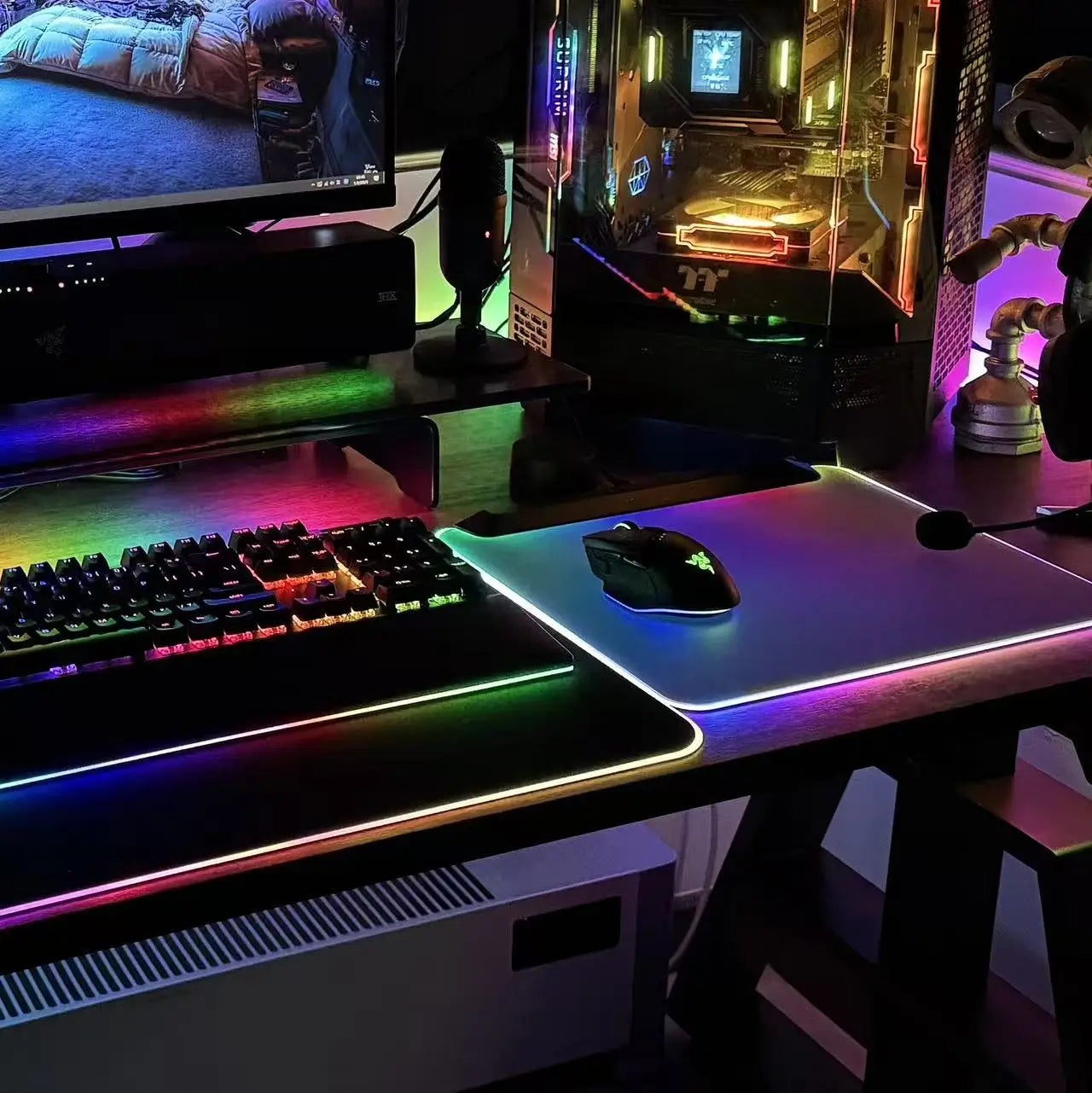 RGB desk mat with black surface and purple-green glowing edge for a gaming setup