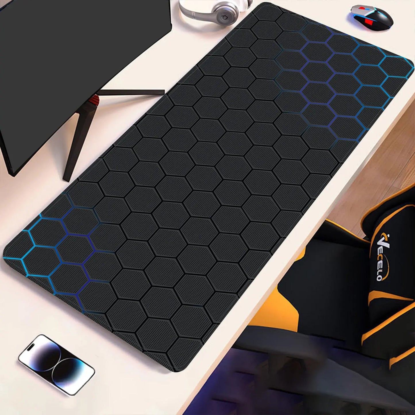 Hex-pattern technical drawing desk pad with blue outline accents on dark surface