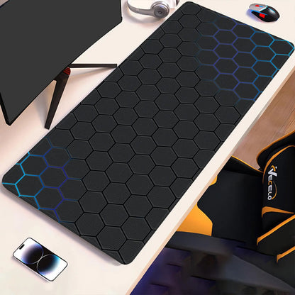 Hex-pattern technical drawing desk pad with blue outline accents on dark surface
