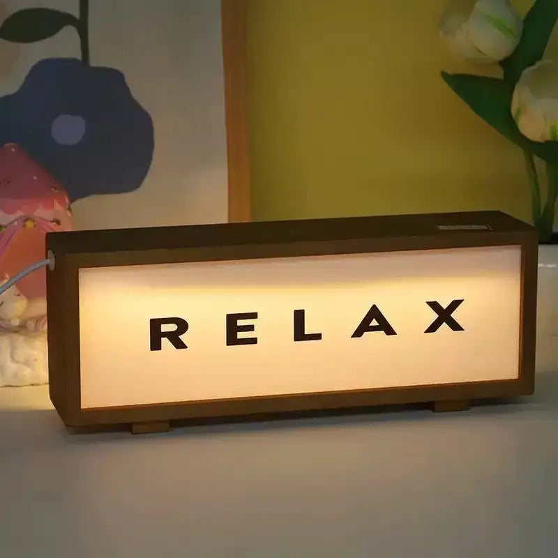 Walnut LED light box with illuminated RELAX text on warm light