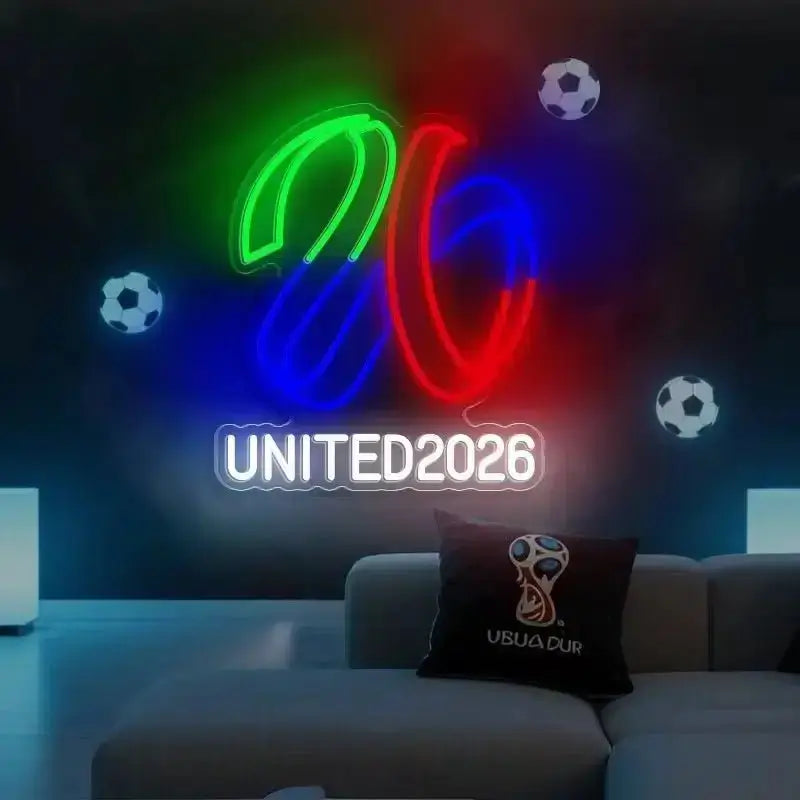 Neon “UNITED2026” sign with multicolor trophy and soccer ball accents