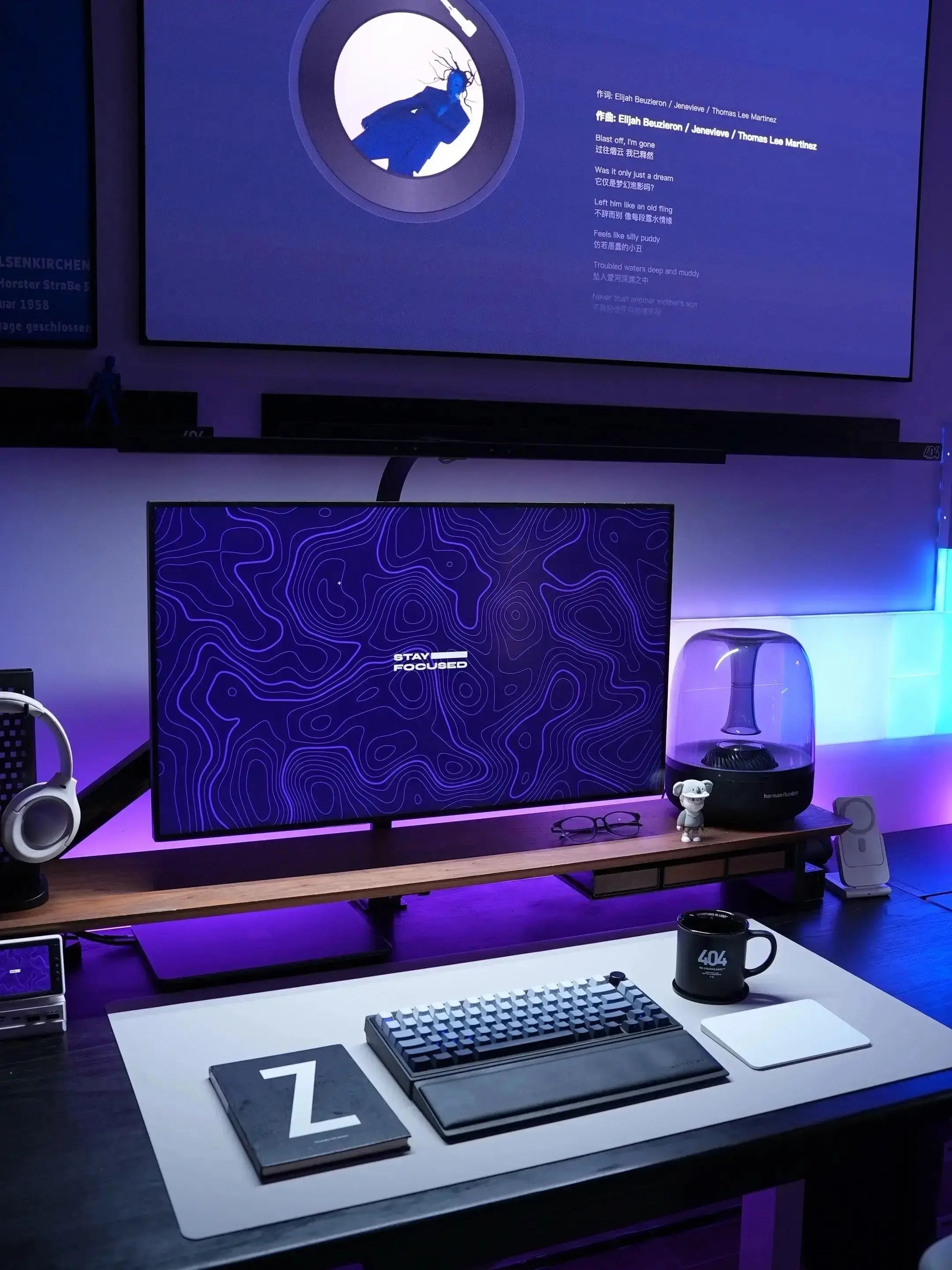 Large gaming desk mat with abstract blue pattern and smooth surface on a desk setup