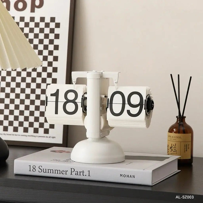Retro flip clock with white flip pages, numbers 18 and 09, white stand and base
